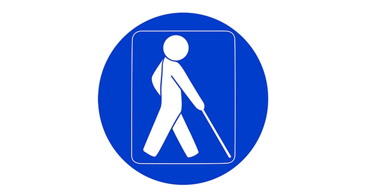 Blå och rund synskadesymbol med en vit figur med vit käpp.